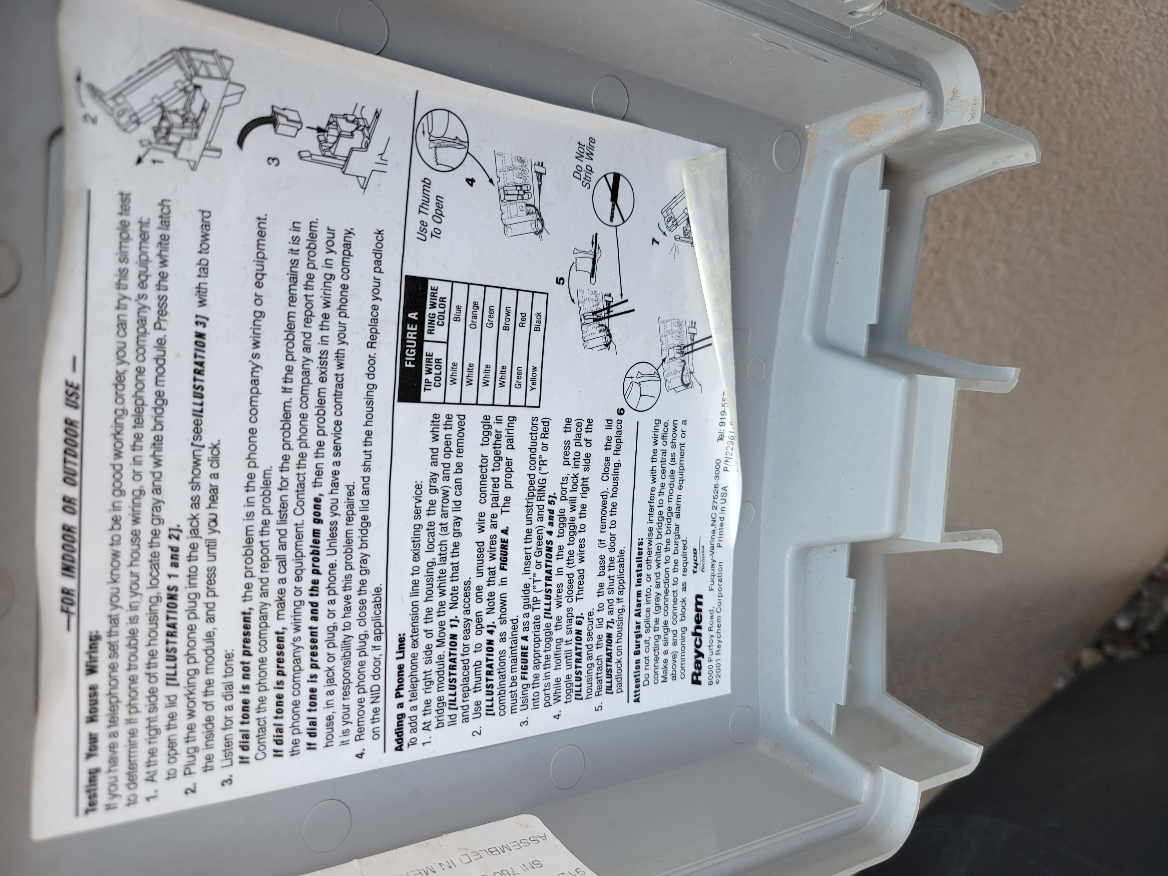 Telephone box instructions for testing the system, adding a new line, and warning burglar alarm installers not to cut a certain wire.